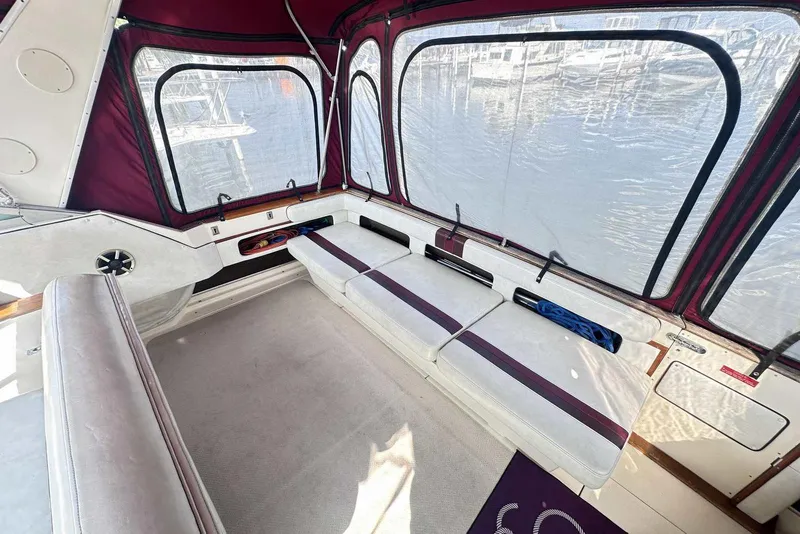 Slide: The Image of Interior of 1987 Sea Ray 340 Sundancer with maroon accents and spacious seating area. - 6