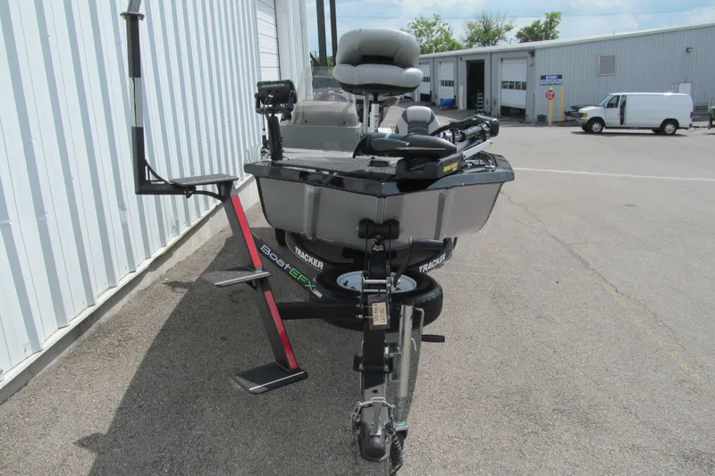 Slide: The Image of 2018 Tracker Pro 160 boat parked outside a building, featuring fishing equipment. - 10