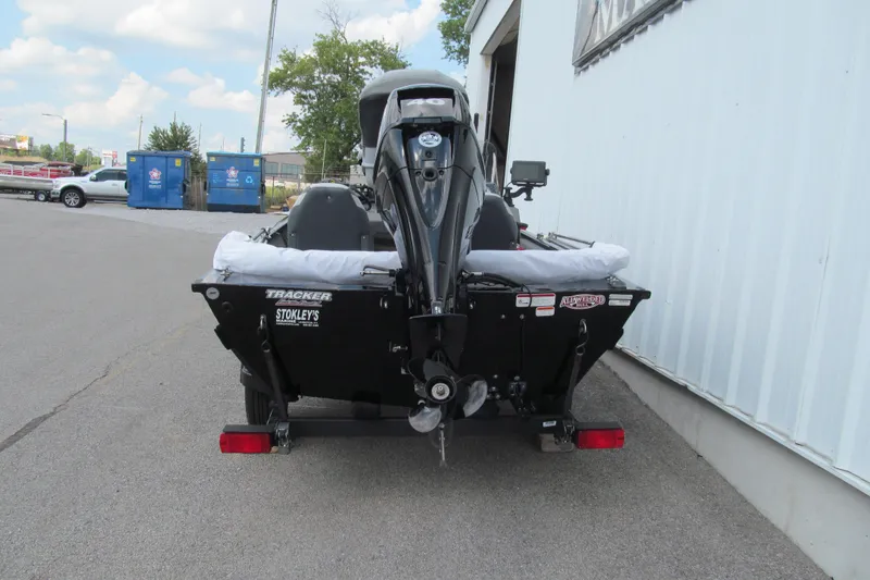 Slide: The Image of 2018 Tracker Pro 160 boat parked outside a building, rear view. - 4