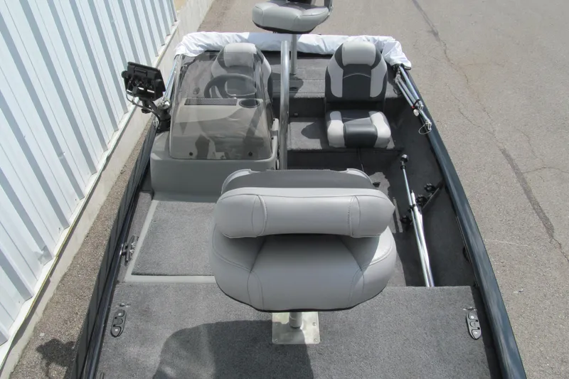 Slide: The Image of 2018 Tracker Pro 160 boat interior with gray seating and steering console. - 9