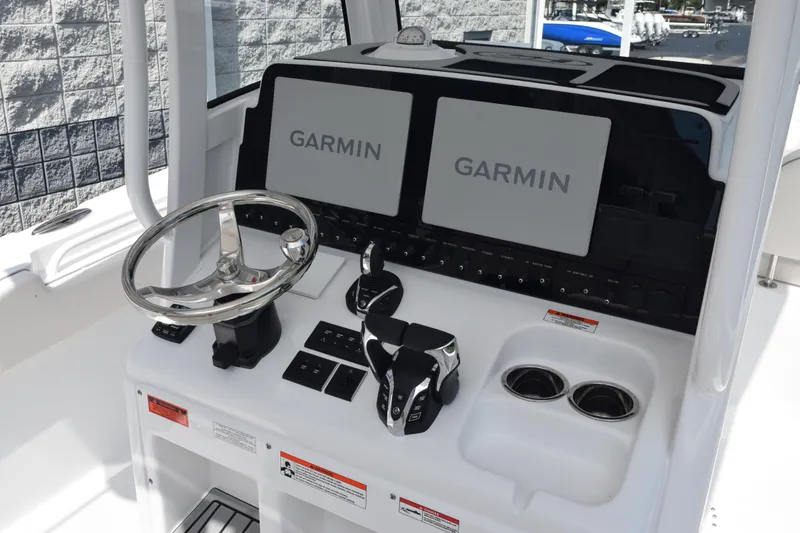 Slide: The Image of 2026 Sea Hunt Gamefish 27 helm with Garmin displays and modern controls. - 10