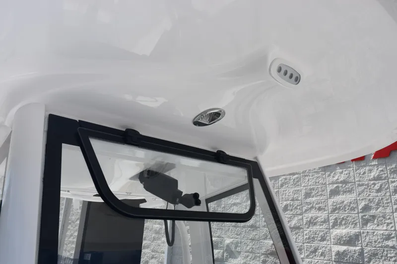 Slide: The Image of 2026 Sea Hunt Gamefish 27 Forward Seating boat interior with window and ceiling details. - 15