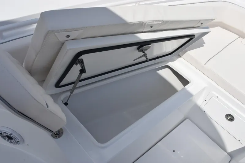 Slide: The Image of 2026 Sea Hunt Gamefish 27 Forward Seating storage compartment open, showcasing interior space. - 17