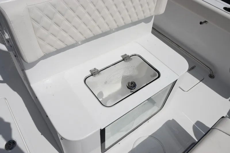 Slide: The Image of 2026 Sea Hunt Gamefish 27 Forward Seating with white cushioned seating and storage compartment. - 26