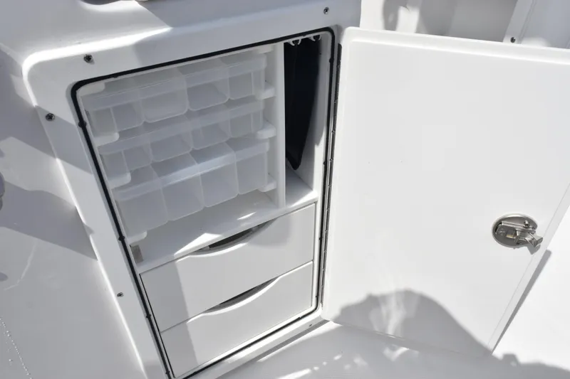Slide: The Image of Open storage compartment on 2026 Sea Hunt Gamefish 27 Forward Seating boat. - 28