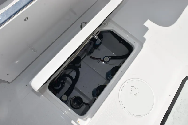 Slide: The Image of 2026 Sea Hunt Gamefish 27 Forward Seating boat compartment with visible wiring and components. - 29