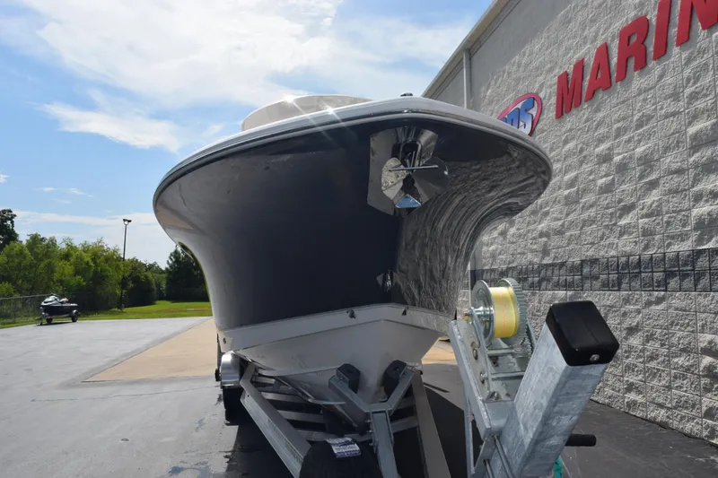 Slide: The Image of 2026 Sea Hunt Gamefish 27 Forward Seating boat on trailer outside marine store. - 3