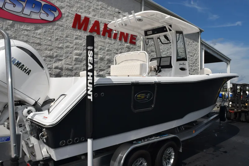 Slide: The Image of 2026 Sea Hunt Gamefish 27 Forward Seating boat displayed at a marine dealership. - 4