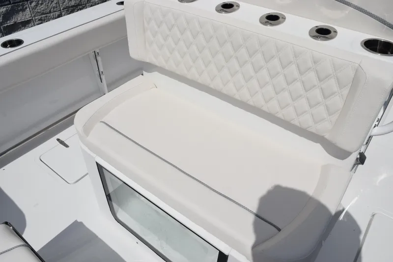 Slide: The Image of 2026 Sea Hunt Gamefish 27 Forward Seating with white cushioned bench and rod holders. - 9