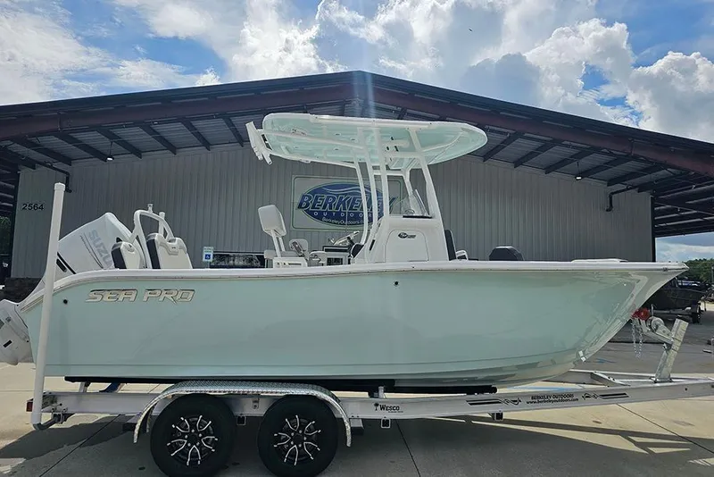 The Image of 2026 Sea Pro 225 Sandbar boat on trailer, parked outdoors under a cloudy sky. - 1