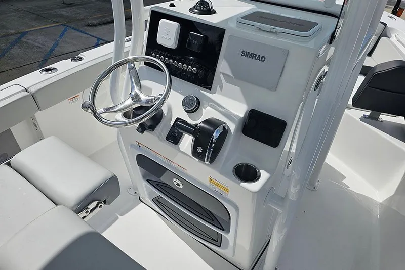 Slide: The Image of 2026 Sea Pro 225 Sandbar boat console with steering wheel and Simrad electronics. - 18