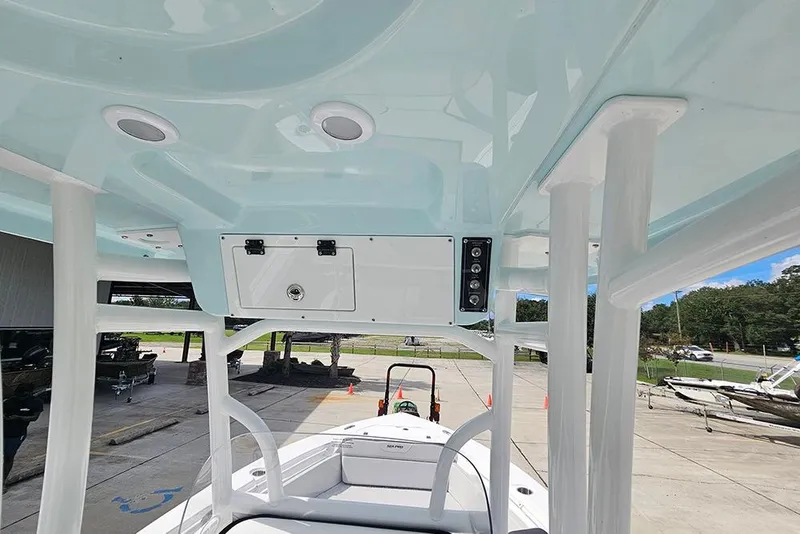 Slide: The Image of 2026 Sea Pro 225 Sandbar boat interior with overhead console and seating area. - 34