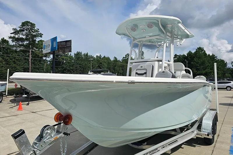 Slide: The Image of 2026 Sea Pro 225 Sandbar boat on trailer, displayed outdoors under cloudy sky. - 5