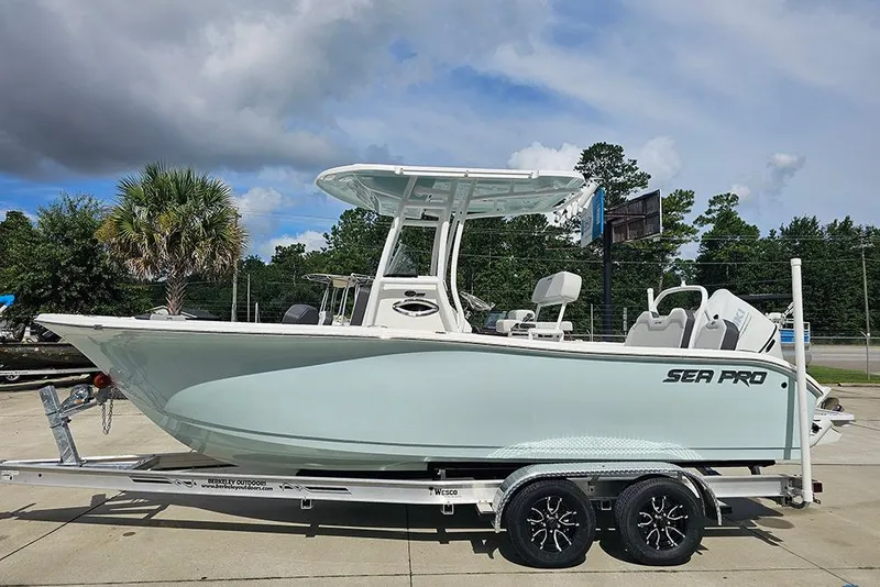 Slide: The Image of 2026 Sea Pro 225 Sandbar boat on trailer, parked outdoors under cloudy sky. - 6