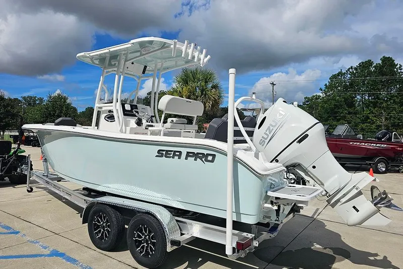 Slide: The Image of 2026 Sea Pro 225 Sandbar boat on trailer, featuring Suzuki outboard motor. - 7