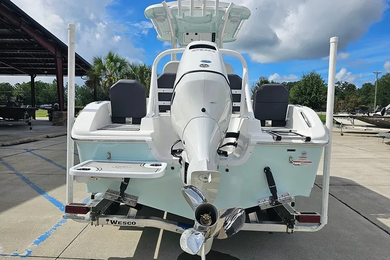 Slide: The Image of 2026 Sea Pro 225 Sandbar boat with outboard motor, parked on a trailer. - 8
