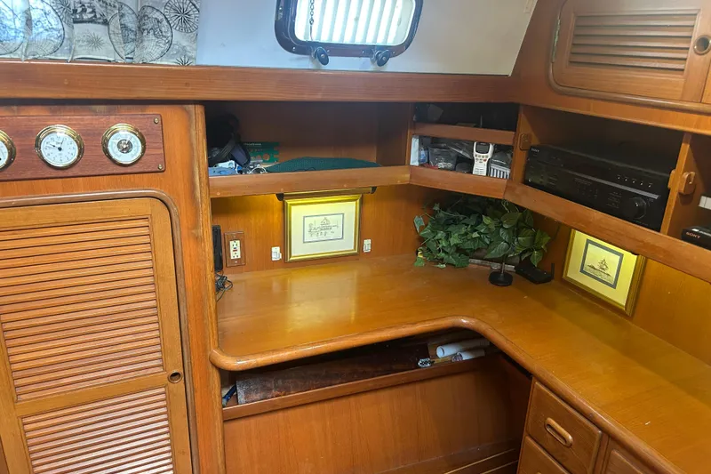 Slide: The Image of Interior of 1995 Tayana 48 sailboat with wooden desk and nautical decor. - 13