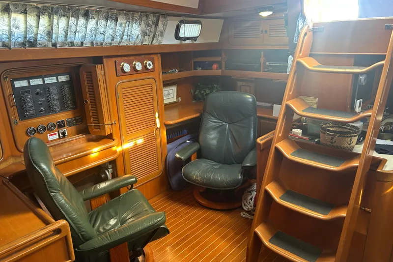 Slide: The Image of Interior of 1995 Tayana 48 yacht with wooden furnishings and leather chairs. - 18