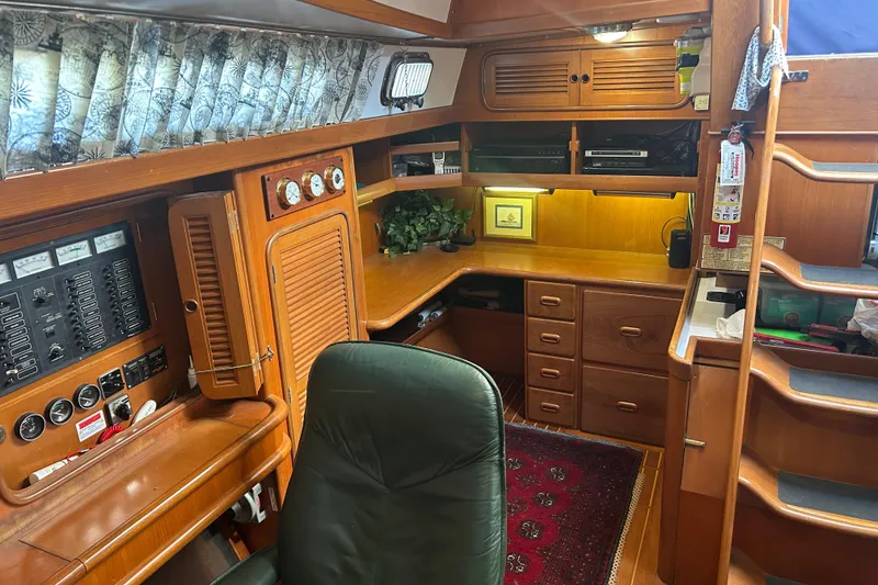 Slide: The Image of Interior of 1995 Tayana 48 yacht with wooden cabinetry and navigation equipment. - 19