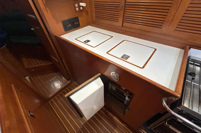 Slide: The Image of Interior of 1995 Tayana 48 yacht with wooden cabinetry and built-in appliances. - 25