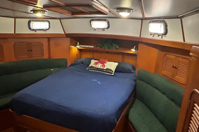 Slide: The Image of Cozy cabin interior of 1995 Tayana 48 yacht with bed and seating. - 30