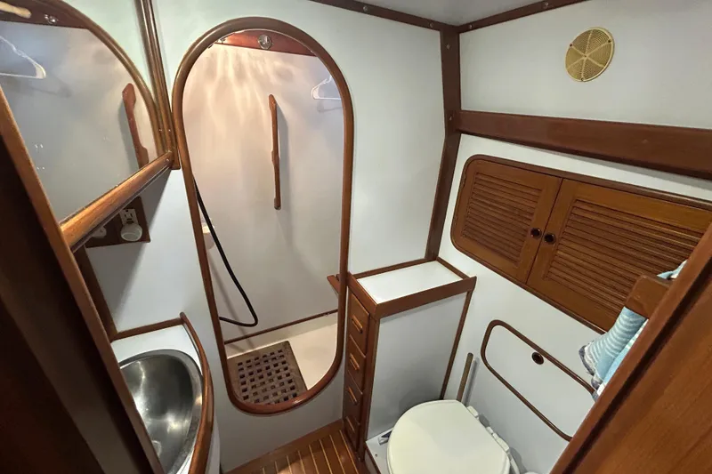 Slide: The Image of Bathroom interior of 1995 Tayana 48 yacht with wooden accents and compact design. - 31