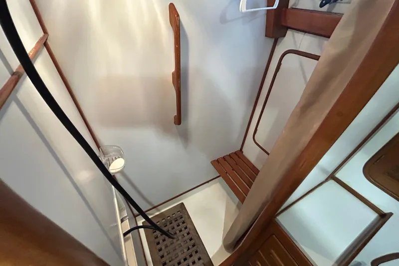 Slide: The Image of Shower area in 1995 Tayana 48 yacht with wooden accents and seating. - 33