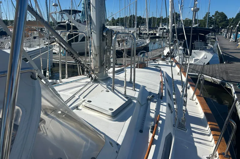 Slide: The Image of Sailboat docked at marina, Tayana 48, 1995 model, with visible deck and rigging. - 41