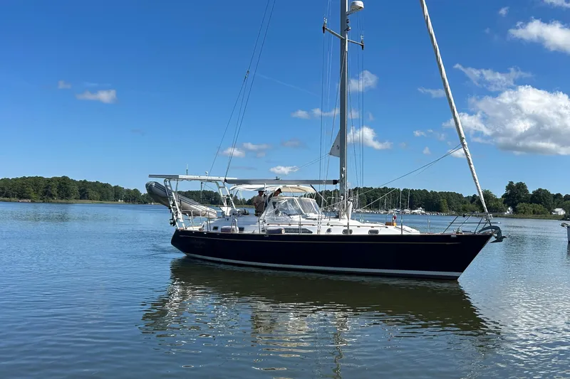 Slide: The Image of Sailboat on calm water, 1995 Tayana 48, under clear blue sky. - 5