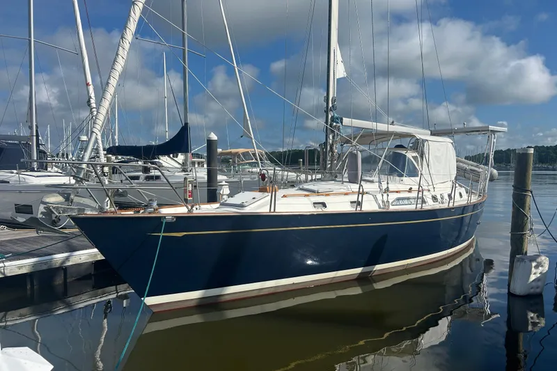 Slide: The Image of Sailboat docked at marina, 1995 Tayana 48 model, blue hull, clear sky background. - 7