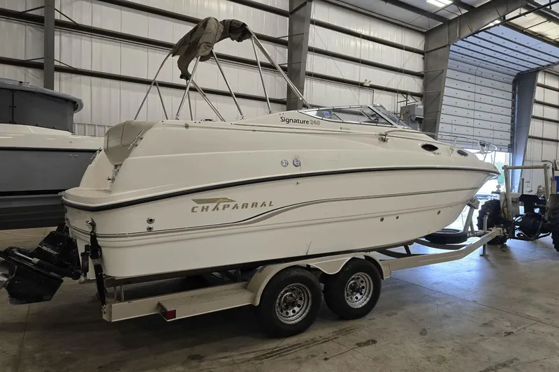 Slide: The Image of 1998 Chaparral Signature 240 boat on trailer in indoor storage facility. - 4