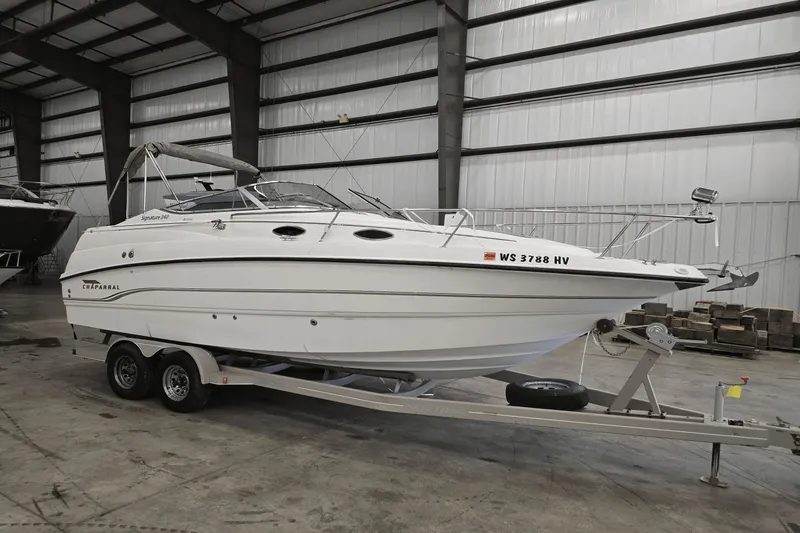 Slide: The Image of 1998 Chaparral Signature 240 boat on trailer in indoor storage facility. - 5
