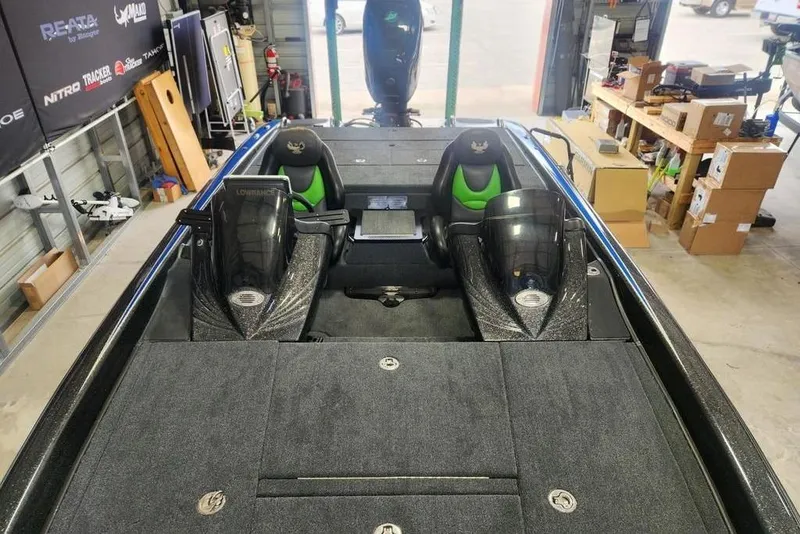 Slide: The Image of 2014 Phoenix 920 ProXP bass boat interior in a garage setting. - 3