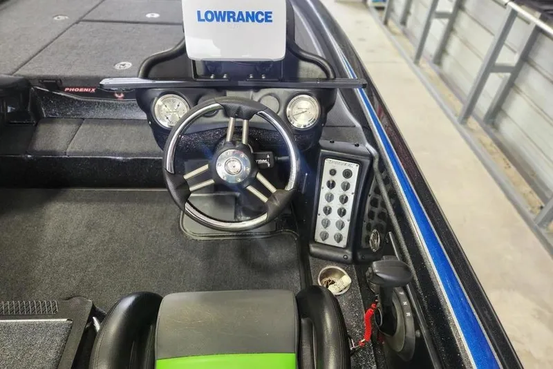 Slide: The Image of 2014 Phoenix 920 ProXP boat dashboard with Lowrance system and steering wheel. - 4