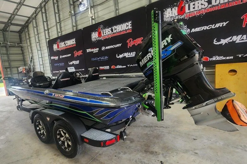 Slide: The Image of 2014 Phoenix 920 ProXP boat with Mercury engine in a garage setting. - 5