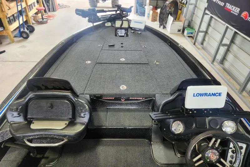 Slide: The Image of 2014 Phoenix 920 ProXP boat interior with Lowrance electronics in a garage setting. - 9