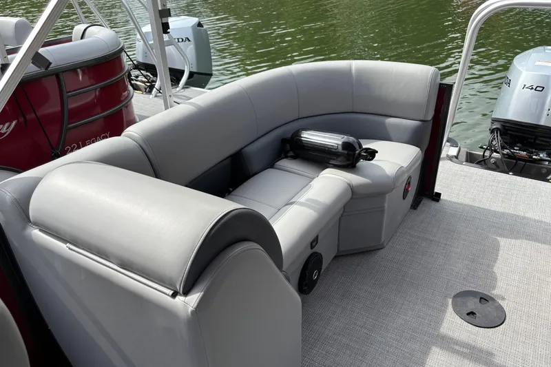 Slide: The Image of 2025 Bentley Pontoons Legacy Navigator with luxurious seating and Honda outboard motor. - 6