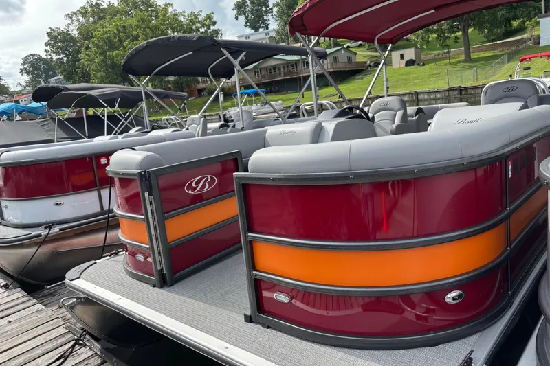 Slide: The Image of 2025 Bentley Pontoons Legacy Navigator docked, featuring sleek design and vibrant colors. - 9