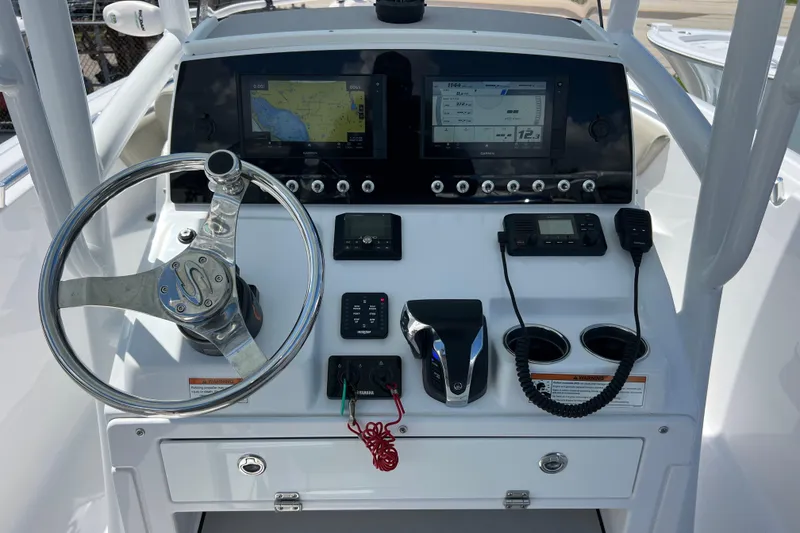 Slide: The Image of 2021 Sportsman Open 232 Center Console dashboard with steering wheel and navigation displays. - 10