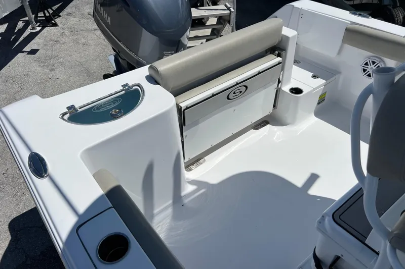 Slide: The Image of 2021 Sportsman Open 232 Center Console boat interior with seating and storage. - 19