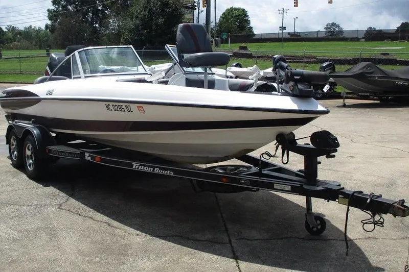 The Image of 2002 Triton TR-21 SFB boat on trailer, parked outdoors. - 0