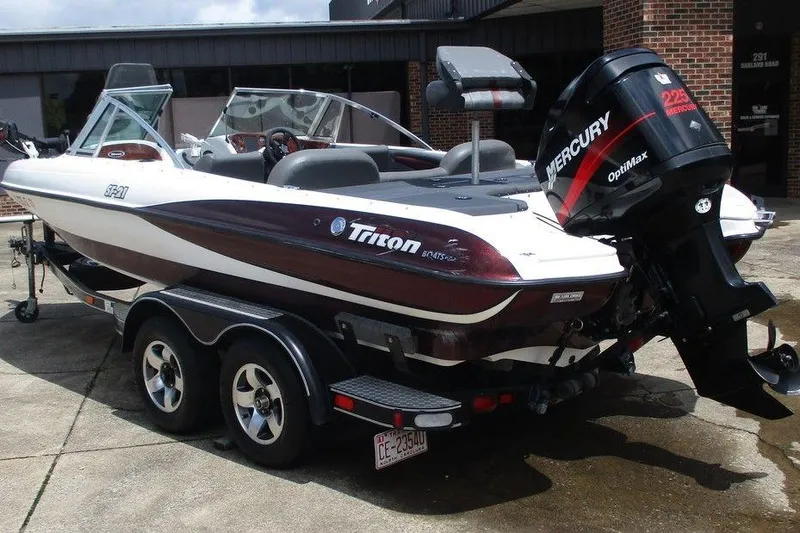Slide: The Image of 2002 Triton TR-21 SFB boat interior with seating and steering wheel, viewed from above. - 2