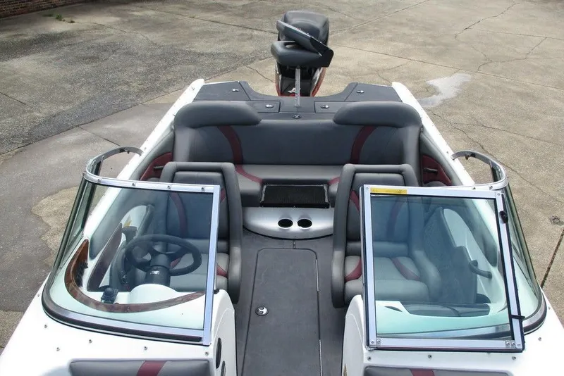 Slide: The Image of 2002 Triton TR-21 SFB boat interior with seating and steering wheel. - 4