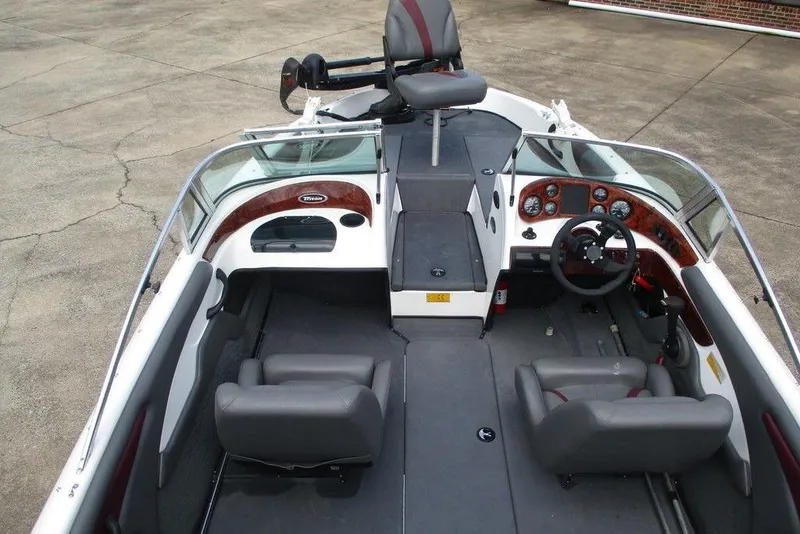 Slide: The Image of 2002 Triton TR-21 SFB boat interior with seating and steering wheel. - 7
