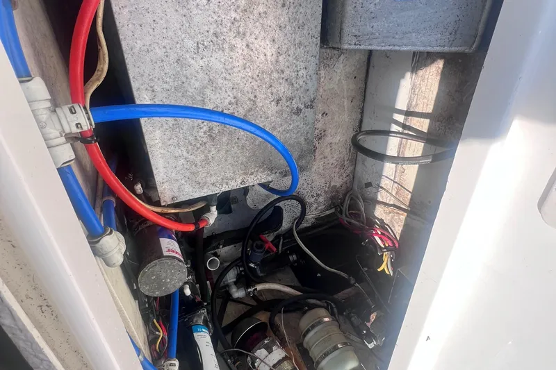 Slide: The Image of 2007 Robalo R305 Walkaround engine compartment with wiring and hoses. - 10