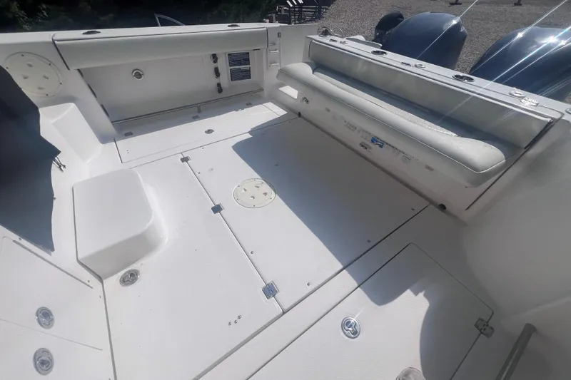 Slide: The Image of 2007 Robalo R305 Walkaround boat deck with seating and storage compartments. - 12