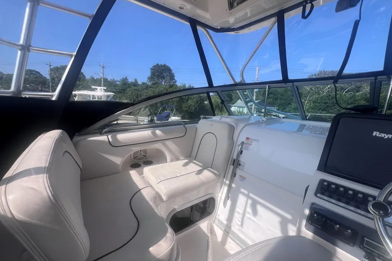 Slide: The Image of 2007 Robalo R305 Walkaround boat interior with helm, seating, and navigation equipment. - 18