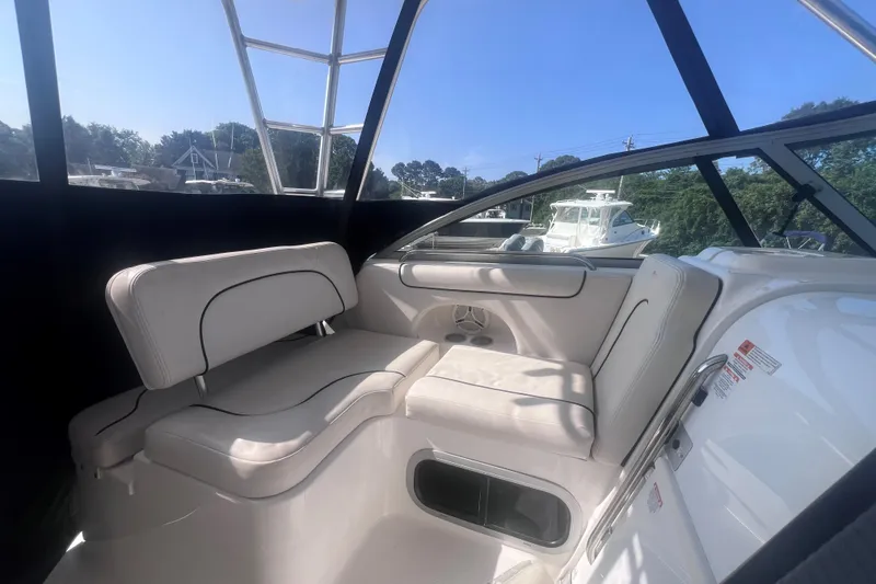 Slide: The Image of 2007 Robalo R305 Walkaround boat interior with white seating and clear windows. - 19