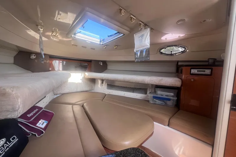 Slide: The Image of 2007 Robalo R305 Walkaround cabin interior with seating, storage, and skylight. - 21