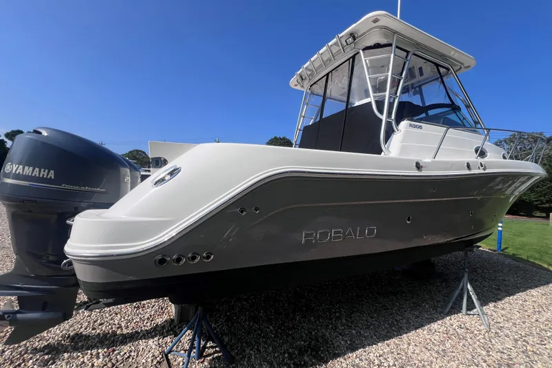 Slide: The Image of 2007 Robalo R305 Walkaround boat with Yamaha engine, displayed on gravel. - 3